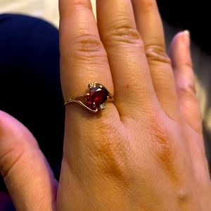10k gold Approximate size 7, Garnet with 1/10 t.w. Diamonds on the side.
